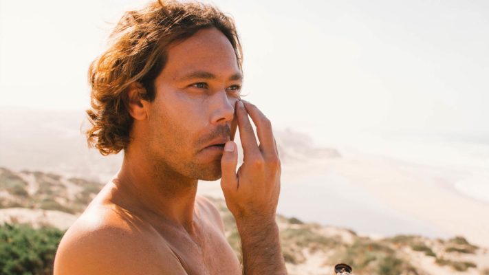 Jordy Smith putting on SWOX sunscreen